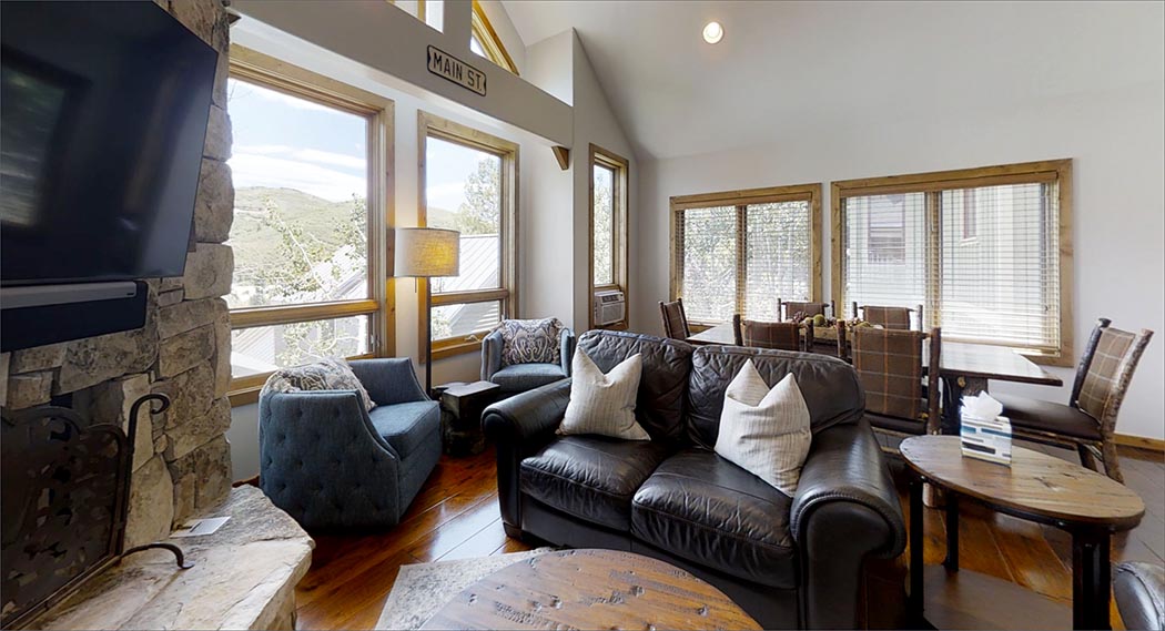 The large living great room includes a fireplace, large flat-screen HDTV with CD and DVD, Stereo and beautiful mountain views.
