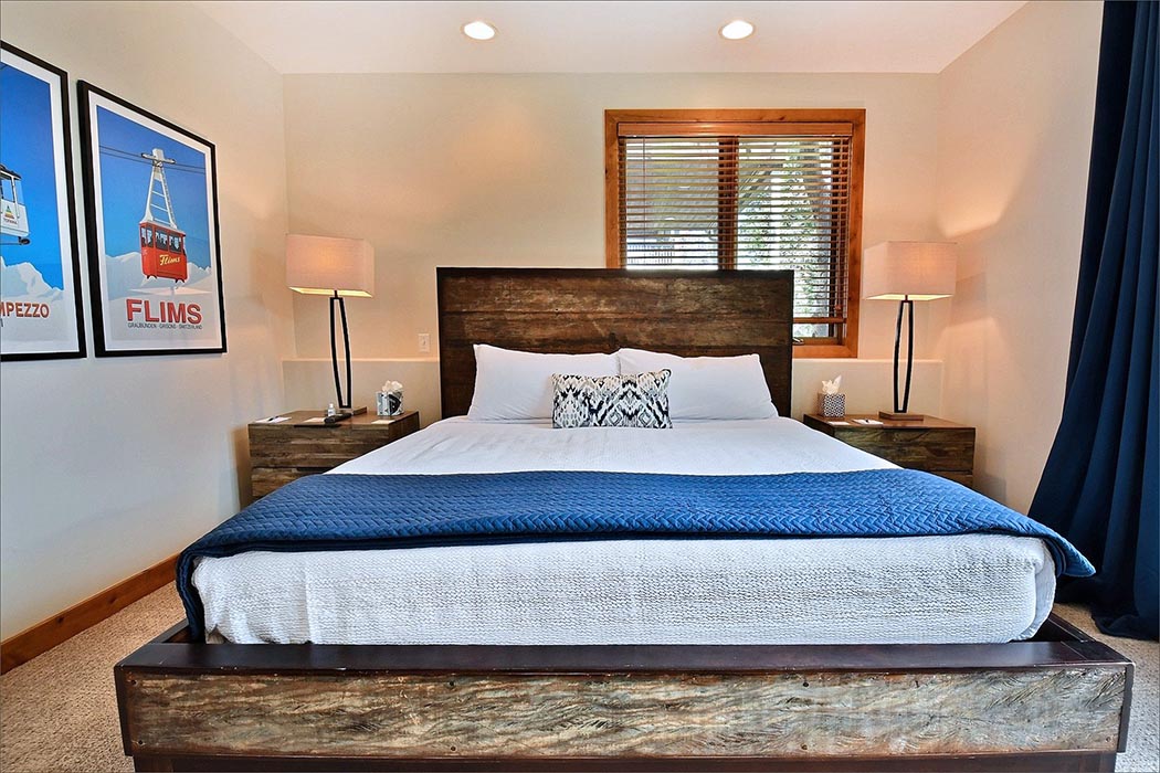 The master bedroom features a large king sized bed, private bathroom and deck with an outdoor hot tub.