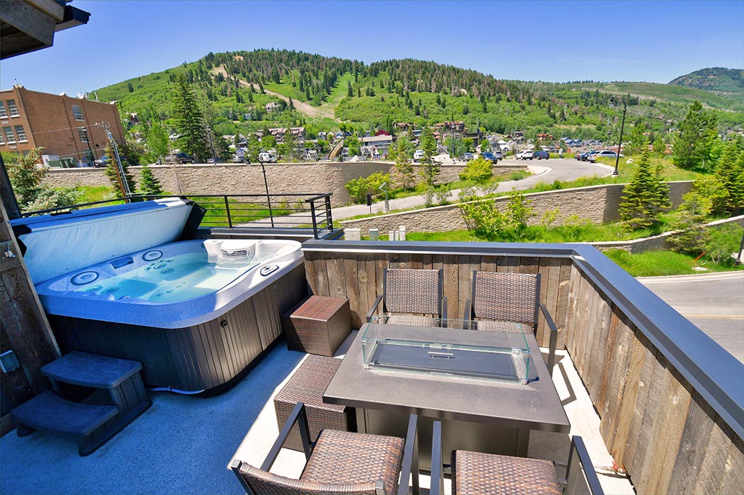 Private deck overlooking Park City features a gas BBQ grill, fire pit, and private hot tub.