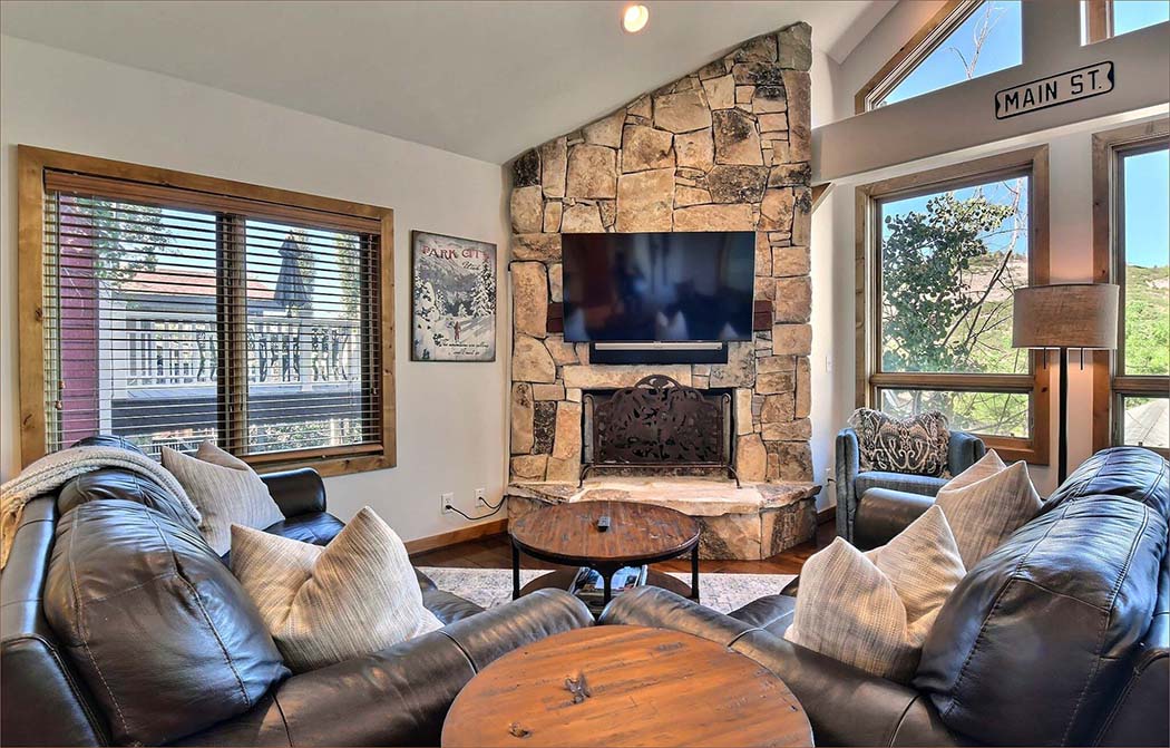 The large living great room includes a huge flat screen TV/entertainment station, stereo, warm fireplace and unforgettable views of the mountain slopes.