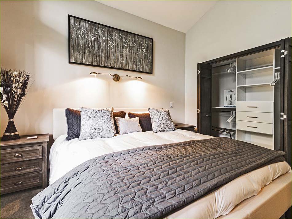 The master bedroom features a large king sized bed, private bathroom and closet.