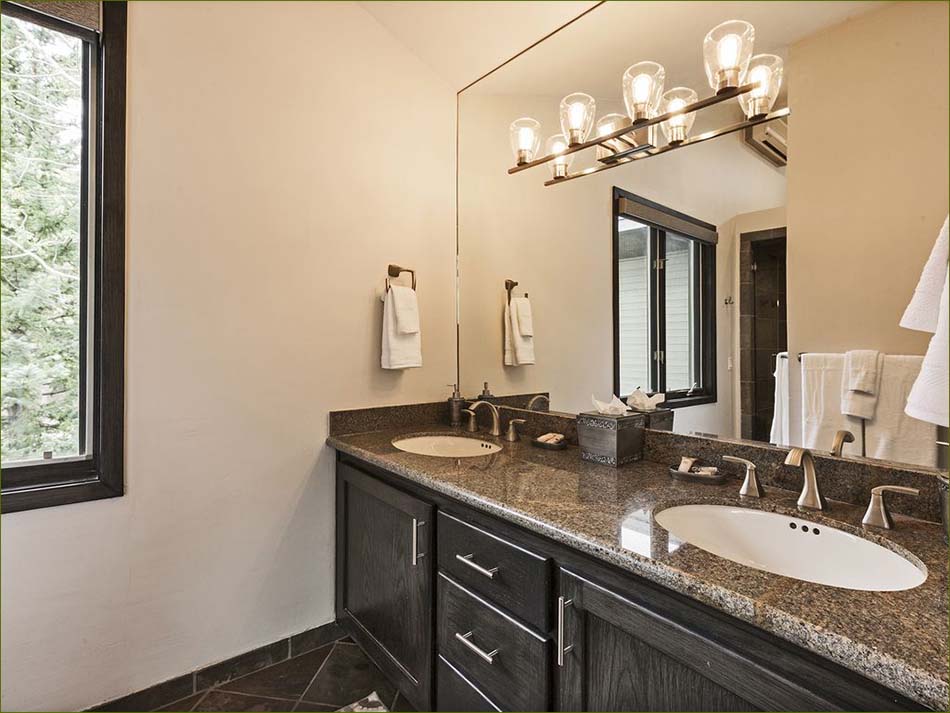 Private main level master bedroom features a closet, double vanity,and slate shower.