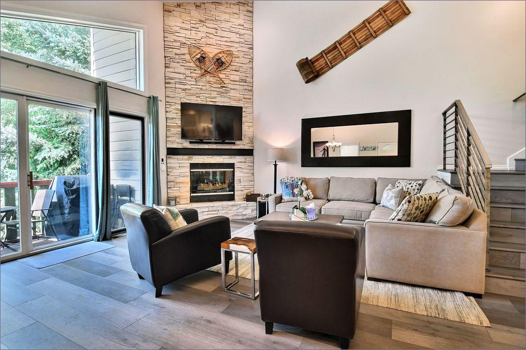 Deep and comfy sectional surrounding the fireplace and large flat screen TV.