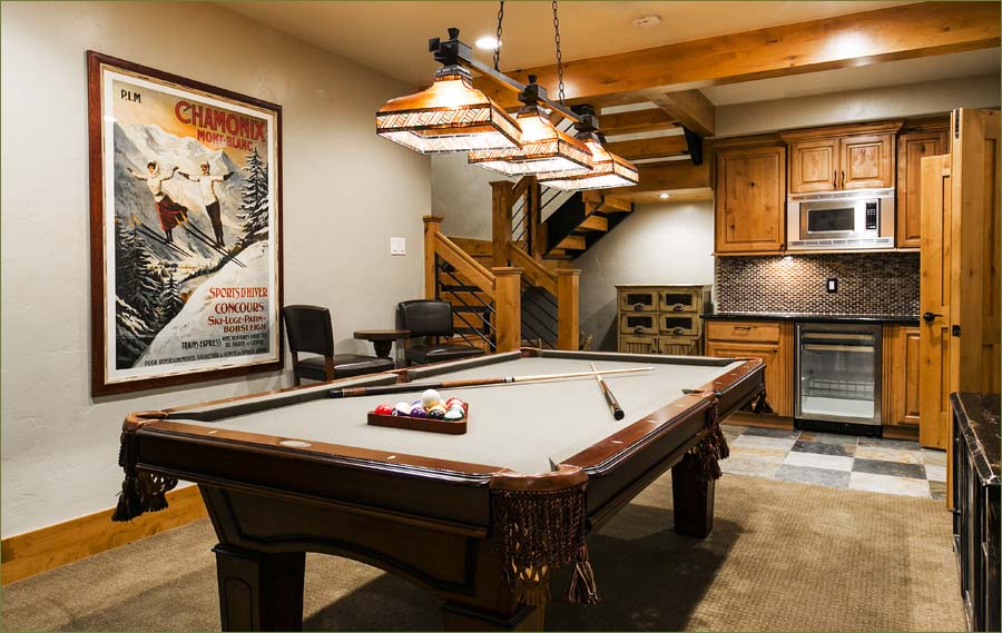 Lower level family room with pool table, seating and kitchenette.