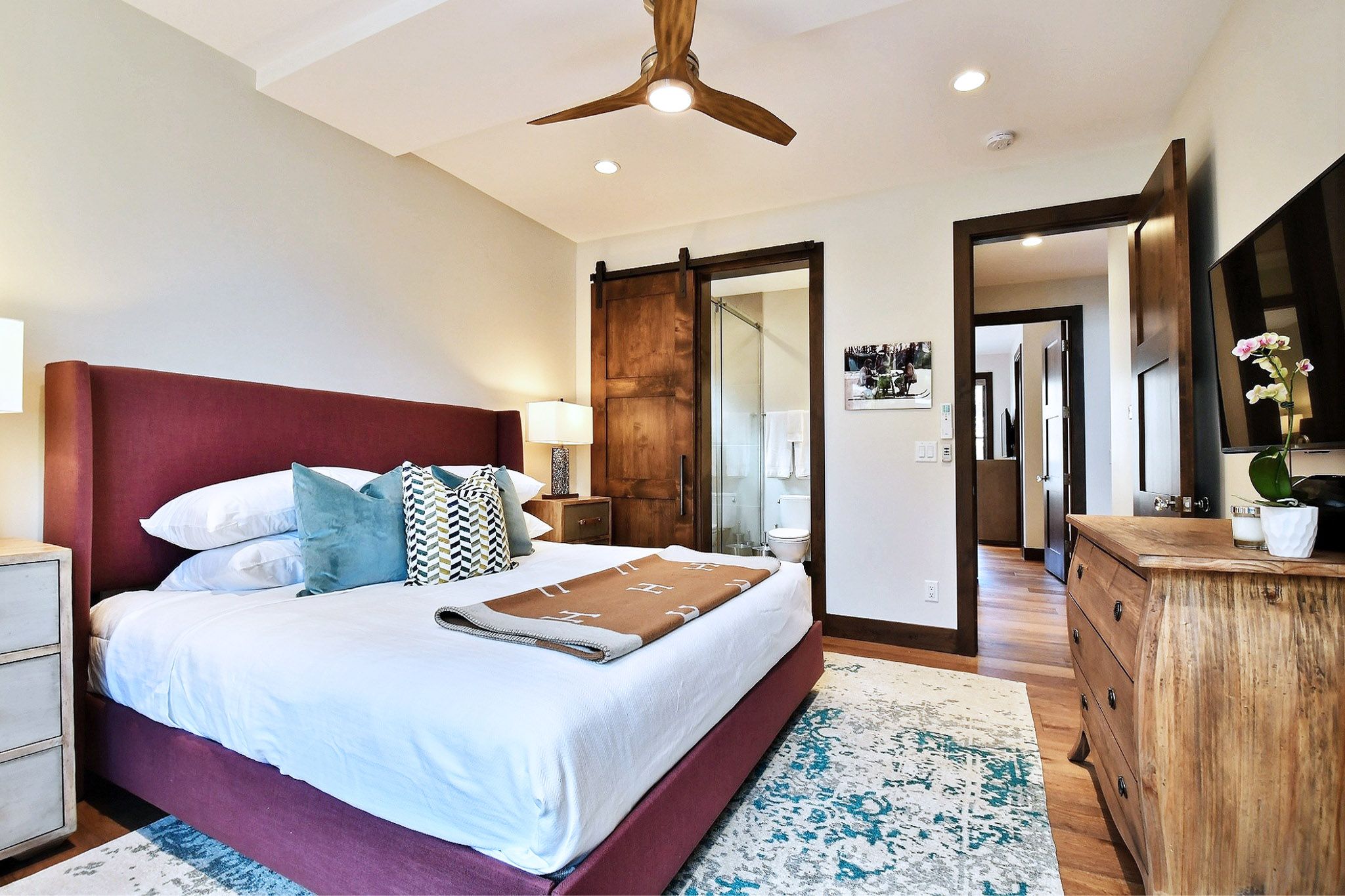 King master suite bedroom with personal ceiling fan, HDTV and attached bathroom.
