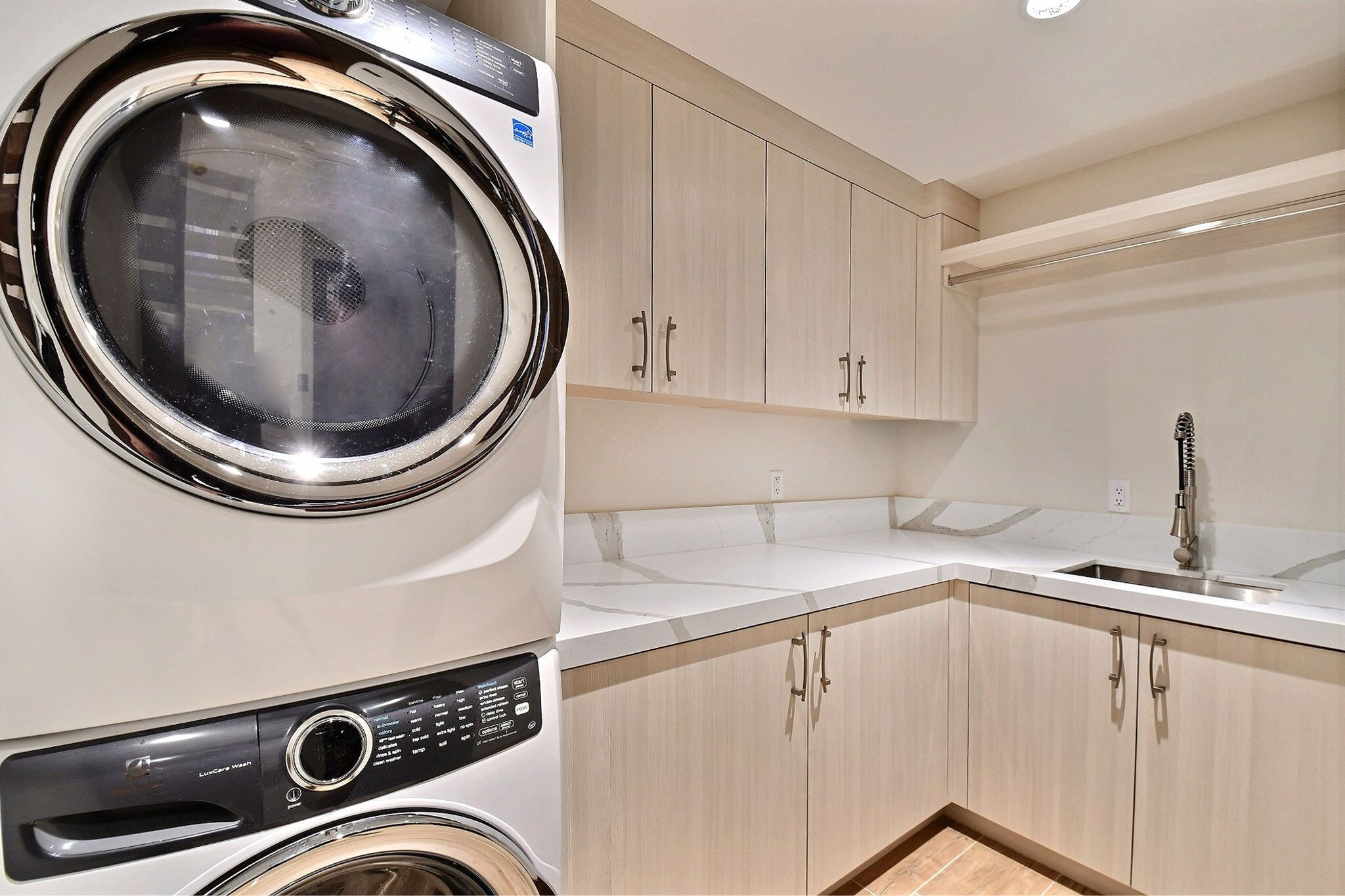 Large laundry with full sized Electolux washer and dryer, ironing board, iron, detergents, dry sheets and more.
