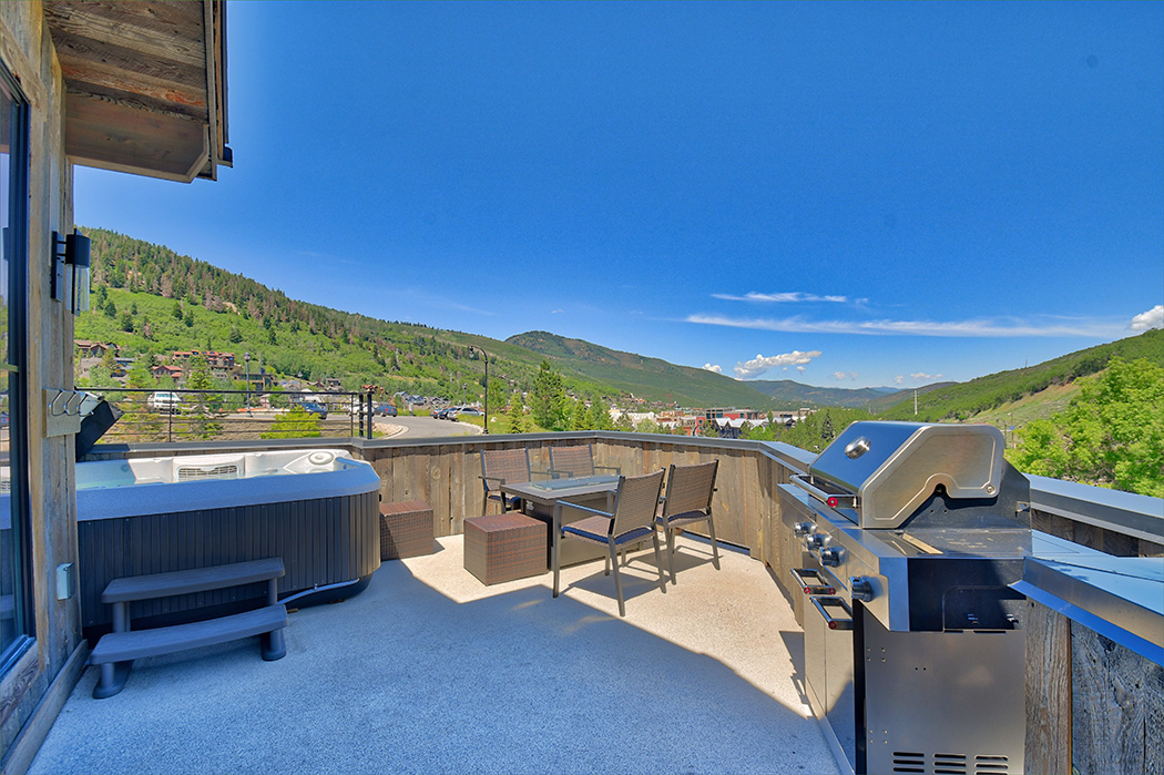 Generous deck includes fantastic views, a gas bbq grill, fire pit, and outdoor seating.
