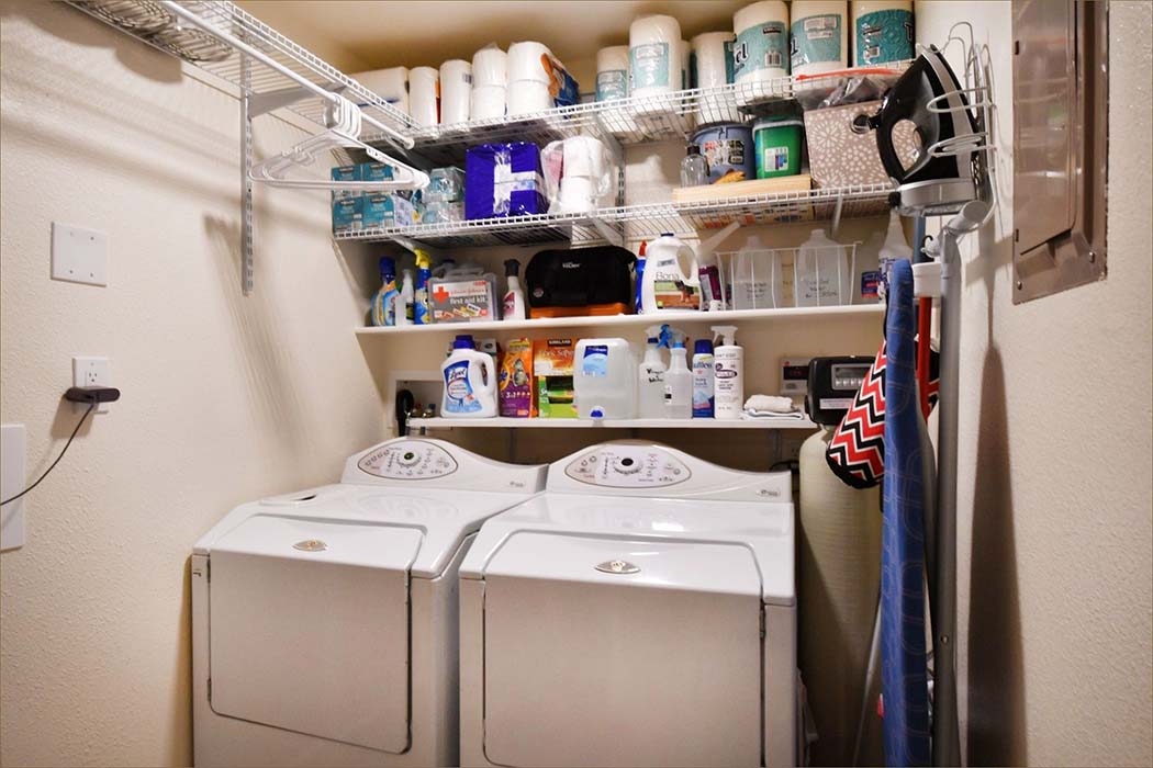 Laundry room with full sized washer and dryer, ironing board, iron and soap and washing necessities provided.